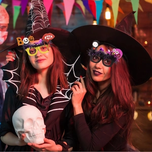 Detail shot of Halloween party glasses featuring sparkly glitter, feathers, and spooky motifs