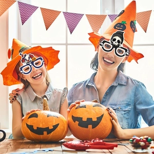 Detail of Halloween party props featuring a witch hat and spooky decorative glasses on models