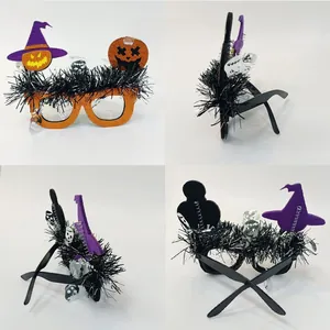 Detail view of Halloween witch hat and pumpkin glitter party glasses with black feathers