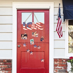 Rustic Independence Day LOVE sign with photo clips and American flag stars on red door