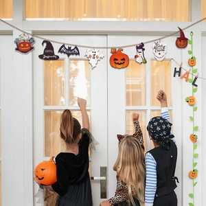 Halloween wooden banner featuring pumpkins and ghosts hanging on a door for party decoration