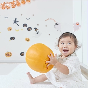 Detail of Halloween ghost headband and glowing pumpkin lantern for infant party decor