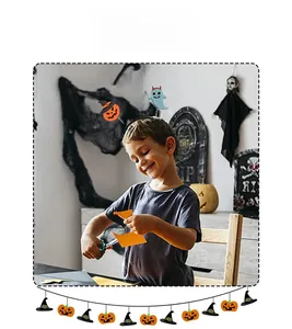 Child wearing Halloween headband with spring pumpkin and ghost during party activities