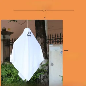 Detailed view of Halloween white ghost hanging decoration with cartoon face in garden