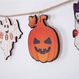 Detail of wooden Halloween hanging decor with pumpkin and BOO ghost on twine string