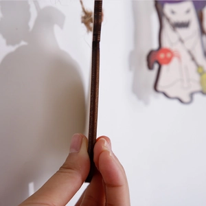 Detail showing the thickness and natural wood grain of the Halloween pumpkin hanging decor