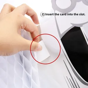 Detail of inserting a white honeycomb ghost card into the slot for assembly instructions