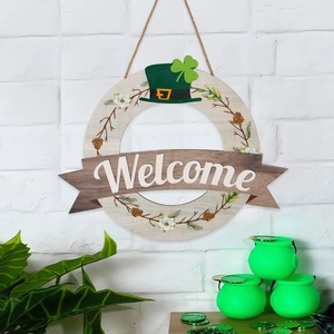 Detail of St. Patrick's Day wooden Welcome sign with green hat and clover on white wall