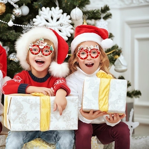 Detail of red Christmas glasses for kids featuring Santa Claus and reindeer designs