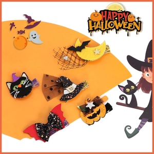 Detail of five Halloween hair clips with glitter pumpkin, witch hat and bat motifs