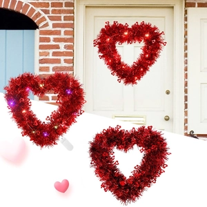 Valentine heart wreath with LED lights and red tinsel for festive door decoration