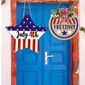 Detail of July 4th wooden door signs featuring Freedom text, star shapes and festive bows
