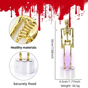 Golden skeleton Halloween desk decor with purple LED glowing base for festive party settings