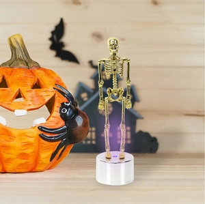 Halloween glowing skeleton figurine on white base with purple light for tabletop decor