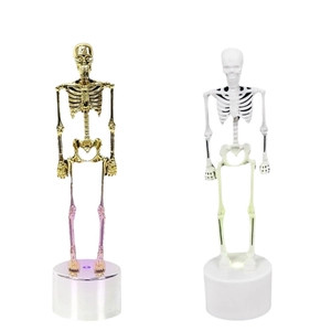 Luminous gold and white skeleton figurines on white bases for Halloween table decor