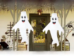 Detail view of two Halloween ghost windsocks with smiling faces for outdoor yard decor