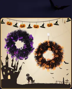 Close-up of Halloween tinsel wreaths featuring bat and pumpkin motifs in purple and orange