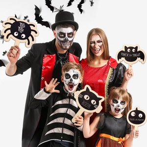 Close-up of wooden Halloween photo props with Trick or Treat and Boo text patterns