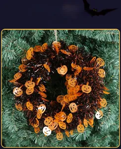 Detail of Halloween wreath with orange pumpkin sequins and black fringe decor