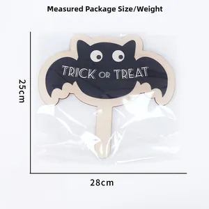 Detail view of wooden Halloween bat sign with Trick or Treat text and dimensions