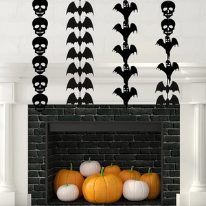 Detail of black Halloween bat and skeleton banner hanging on a white fireplace mantle