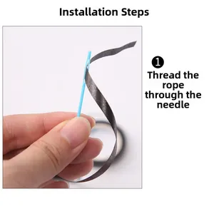 Installation step showing how to thread the black cord through the blue plastic needle
