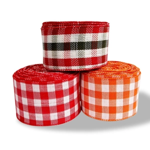 Three rolls of Christmas plaid burlap ribbons with red and white Scottish checkered patterns