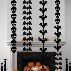 Halloween hanging banners with black skull bat and ghost shapes over a white fireplace