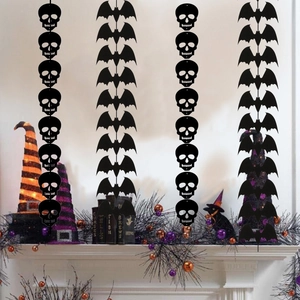 Close-up of Halloween hanging decorations featuring black skeleton and bat garland strings