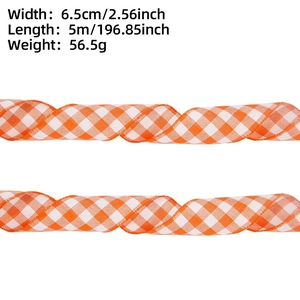 Detail showing 6.5cm wide orange and white plaid ribbon dimensions for holiday gift wrapping