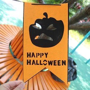 Orange Halloween banner with pumpkin face and Happy Halloween text for party decor