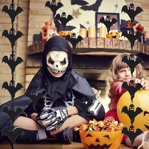 Halloween black ghost hanging ornaments displayed by children in a cozy home fireplace setting