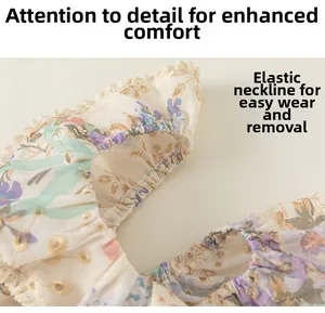 Détail de robe fleurie pour fille avec broderie ajourée et encolure élastique confortable