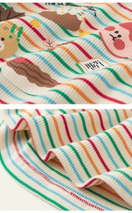 Detail von regenbogengestreiftem Rippenstrick mit niedlichem Bären- und Torten-Stickerei