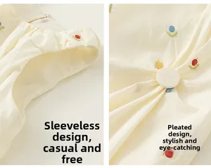 Detail of embroidered floral patterns and soft pleats on girls sleeveless beige dress