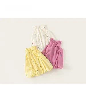Detailed view of kids' bubble hem dresses with floral embroidery in multiple colors