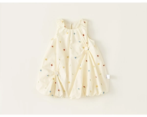 Detail of toddler floral bubble dress with intricate embroidery and large buttons