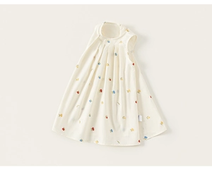 Detail of child sleeveless dress with tulip print and pleated neckline on beige fabric