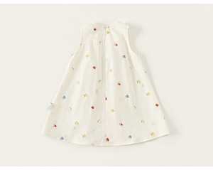Detailed close-up of cream sleeveless dress with floral embroidery and washing label