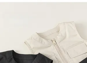 Detail of baby sleeveless cargo vest showing dual large pockets and smooth zipper closure