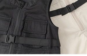 Close-up of tactical cargo vests with central resin zipper and adjustable buckle straps