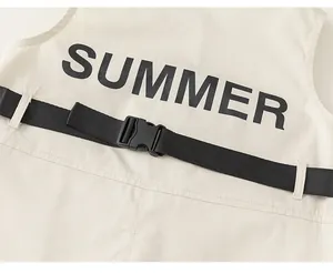 Detail view of khaki boy's summer romper showing black buckle strap and SUMMER back print