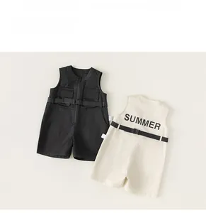 Detail view of boy's summer cotton utility rompers in black and beige with belt