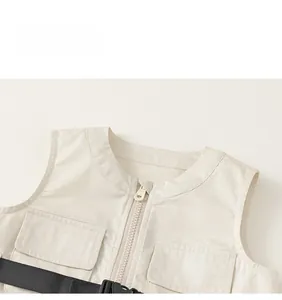 Detail view of cream cargo vest showing zipper closure, chest pockets and black nylon belt