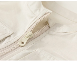 Detailed macro view of the light beige woven fabric and zipper with BBG engraving