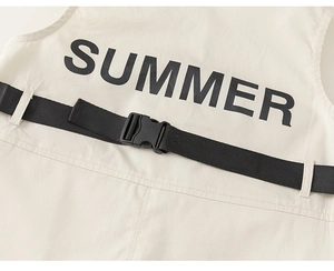 Detail of toddler beige romper featuring a black plastic buckle and Summer print