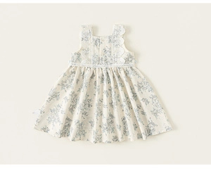 Detail of floral girl dress featuring white lace collar and delicate blue flower print