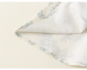 Detailed macro view of blue floral cotton fabric with fine stitching and breathable texture