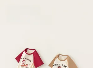 Detail of children raglan t-shirts with cartoon prints and contrast sleeve stitching