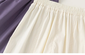 Detail of high-elastic pleated waistbands on purple and beige lightweight summer trousers